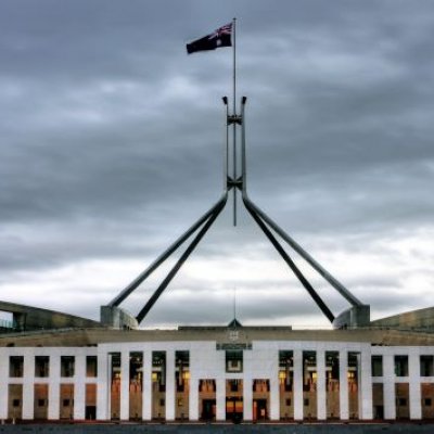 Parliament house in Canberra under a gloomy sky. Adobe.